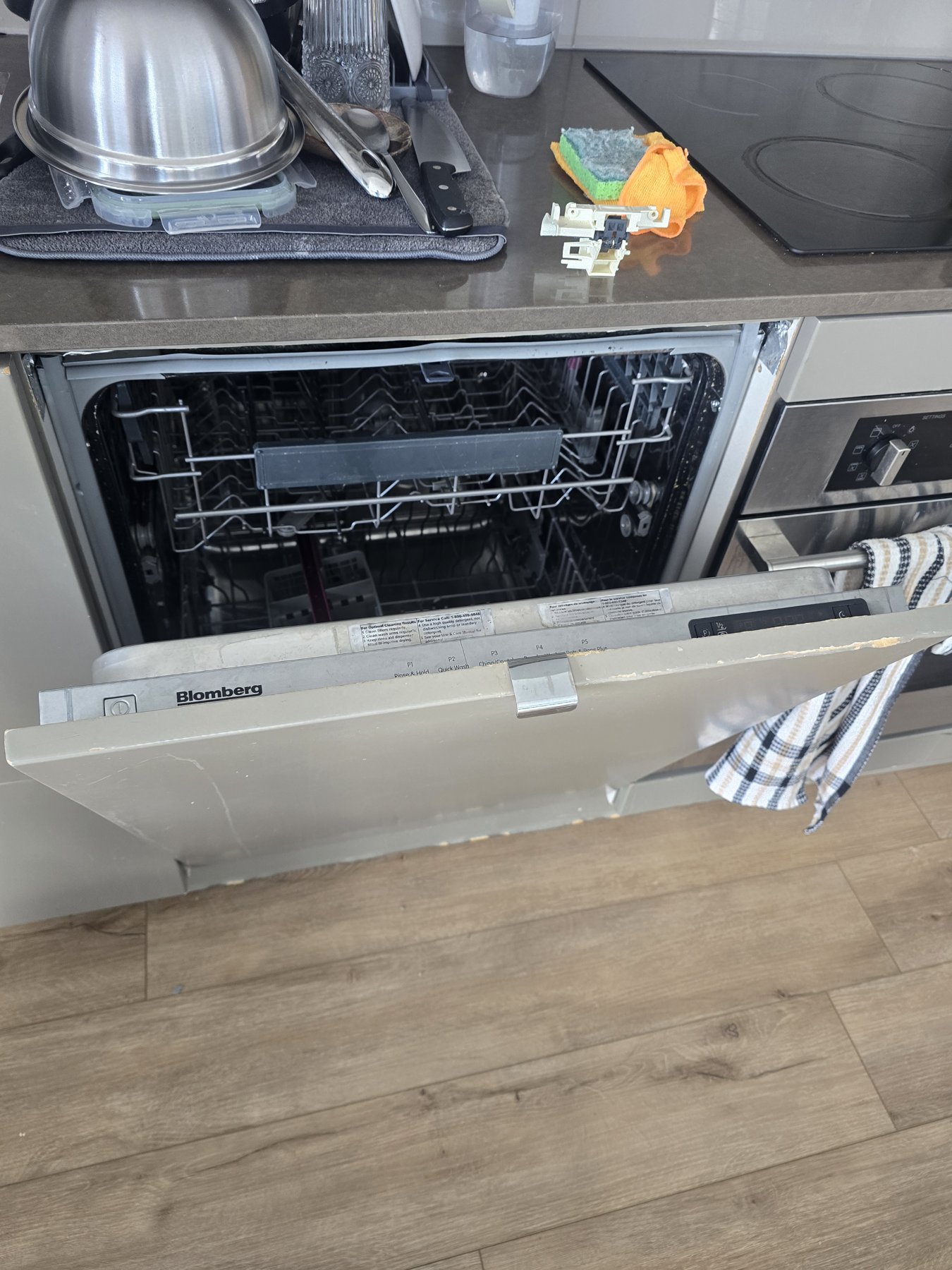 Blomberg dishwasher with the decorative door panel refitted and the door open after latch replacement