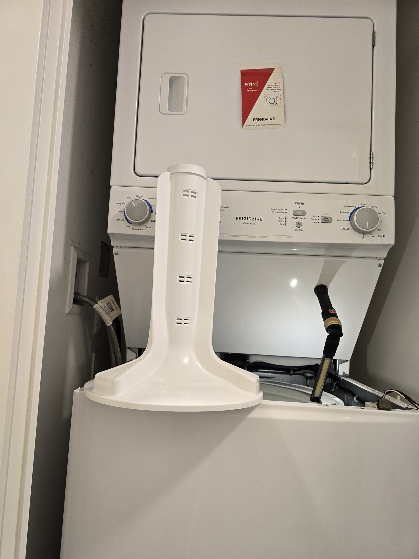 White washer agitator positioned in front of a Frigidaire laundry centre during replacement