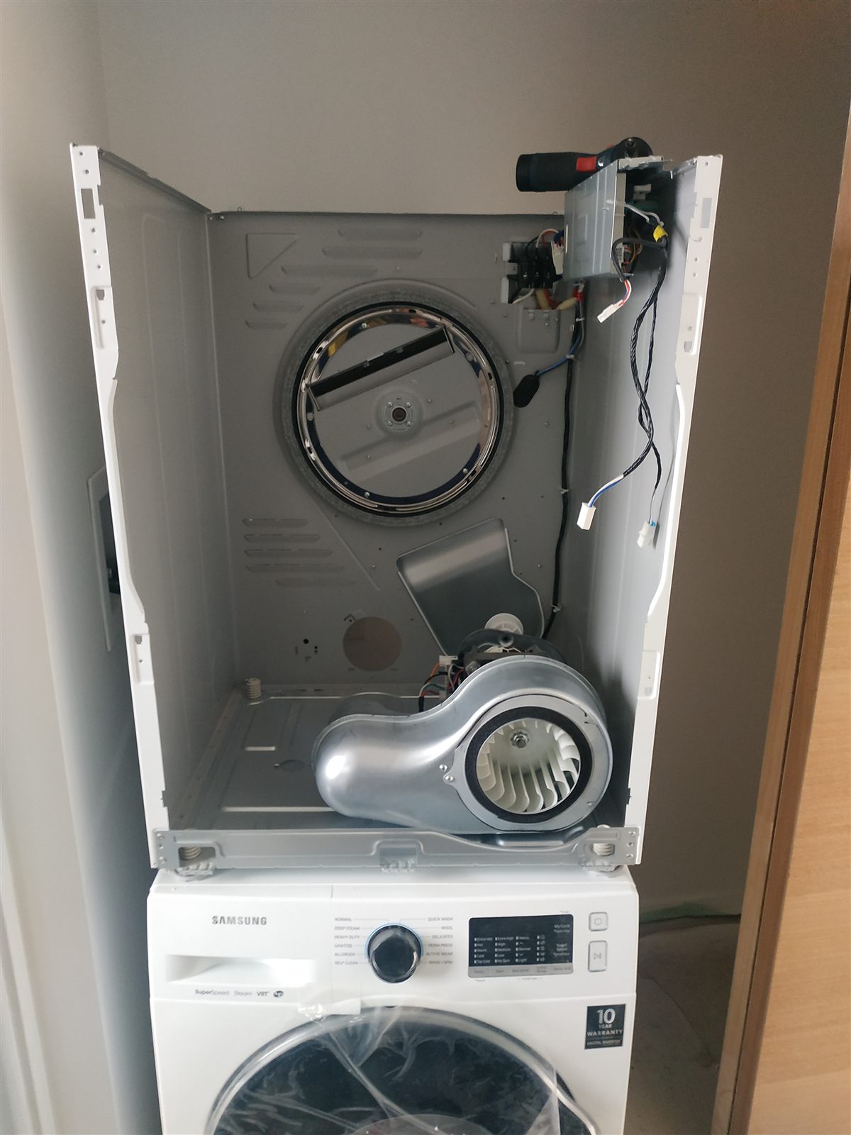 Open laundry appliance cabinet during washer and dryer service